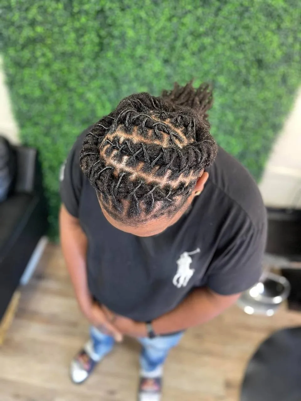Overhead view of a man's retwisted locs with neat parts