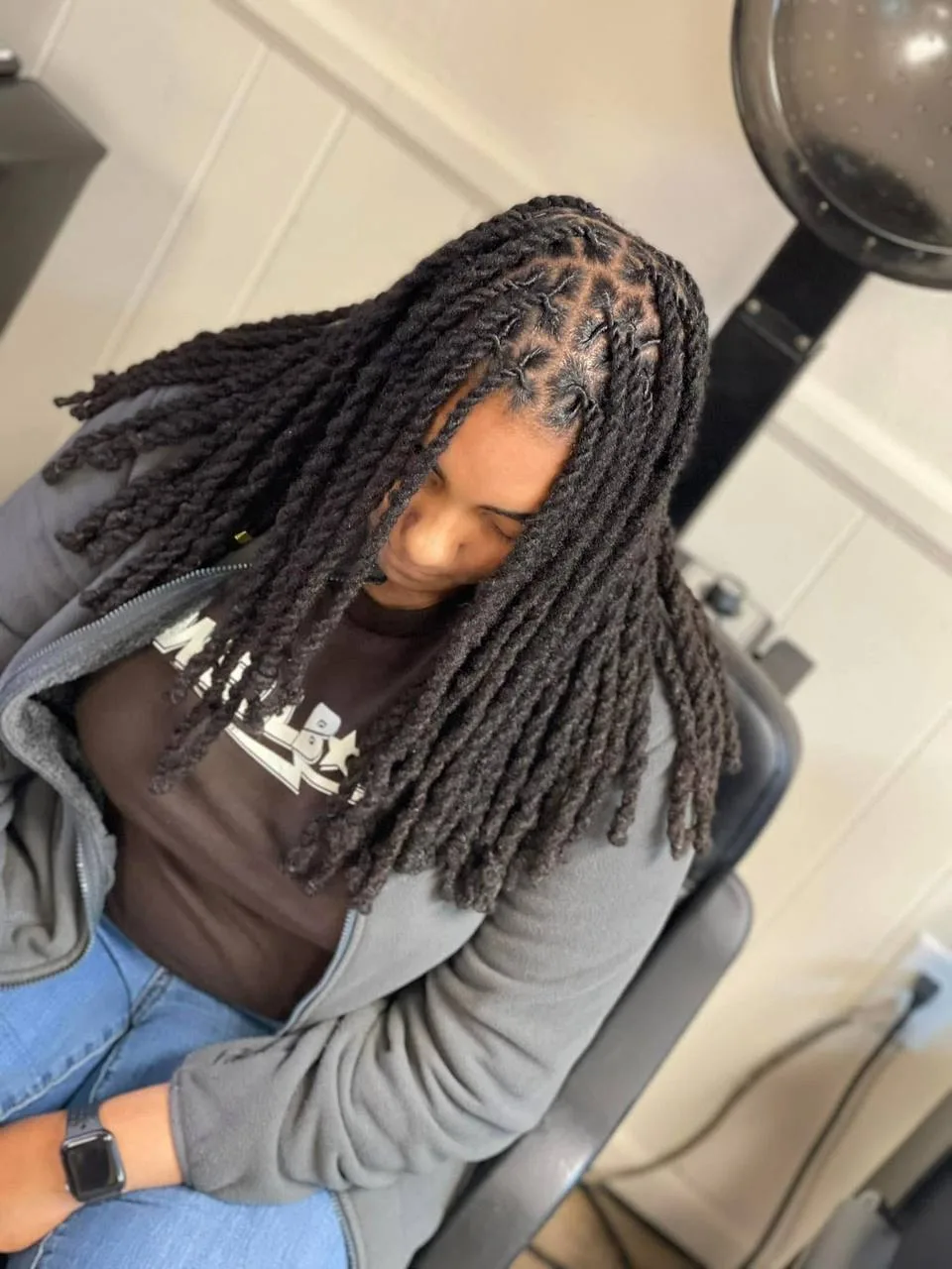 Client in the salon chair showing long, full locs